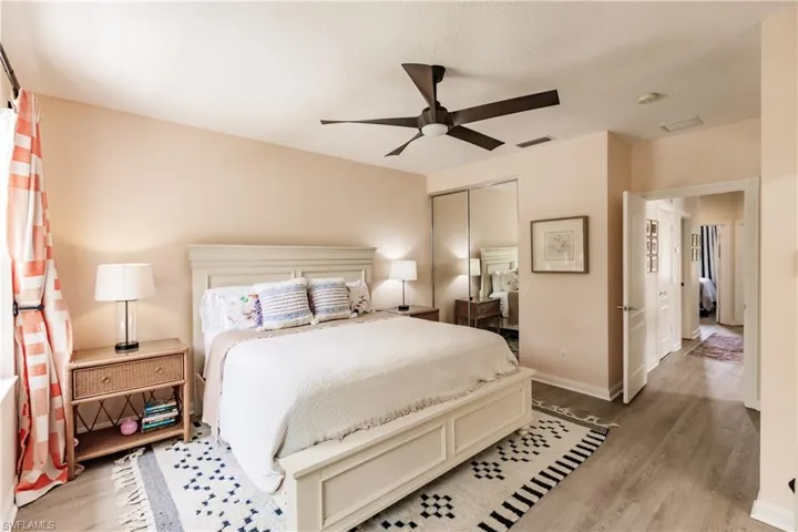 Bedroom featuring ceiling fan, hardwood / wood-style flooring, and a closet