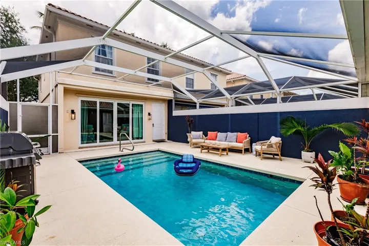 View of swimming pool with a lanai, a patio area, and an outdoor living space