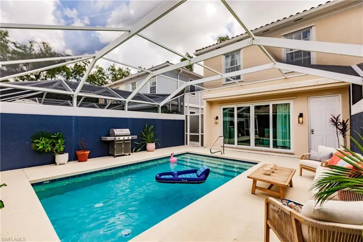 View of pool with a patio, a lanai, grilling area, and outdoor lounge area