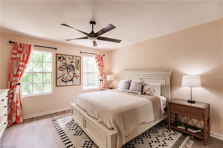 Bedroom with ceiling fan and light wood-type flooring