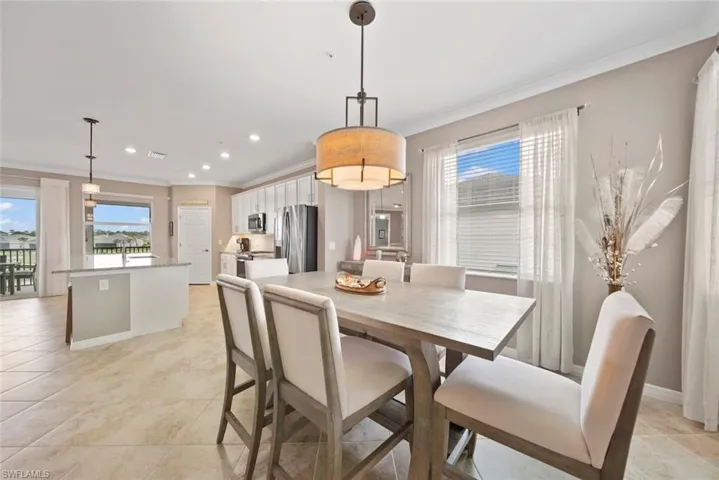 Tiled dining area with crown molding