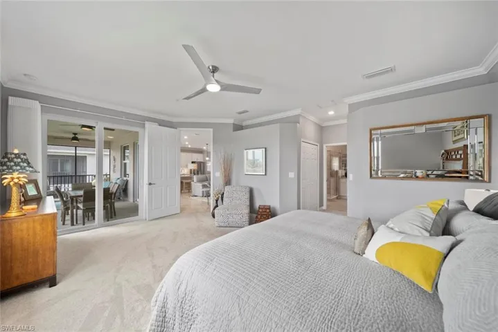 Bedroom featuring light carpet, ceiling fan, access to outside, crown molding, and a closet