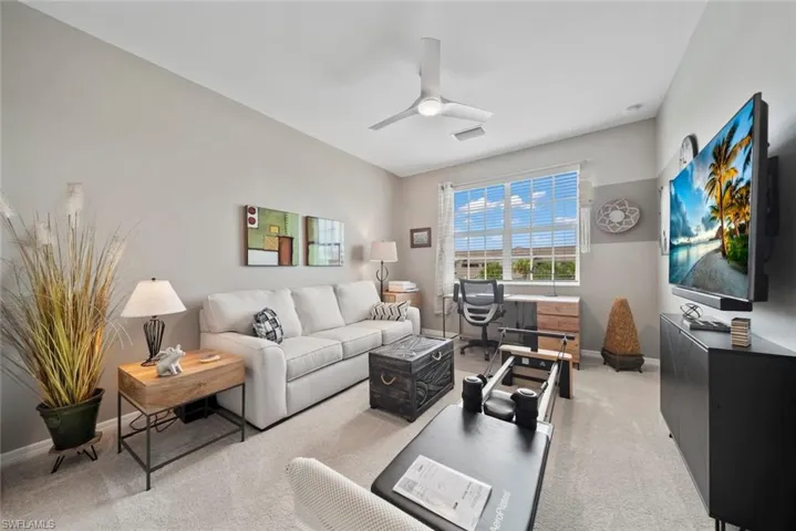 Living room featuring light carpet and ceiling fan