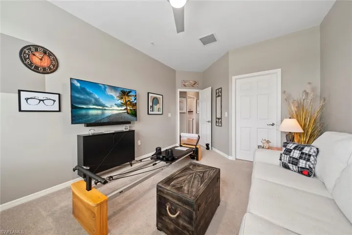 Living room featuring light colored carpet and ceiling fan