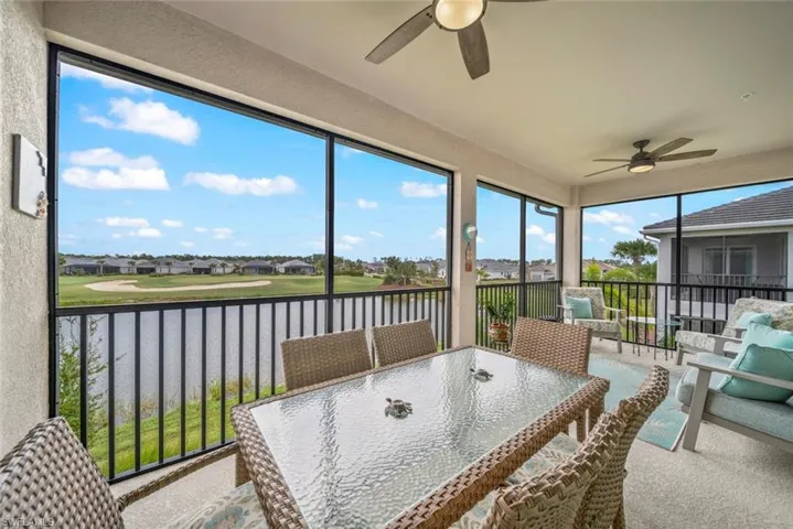 Sunroom with a water view and ceiling fan