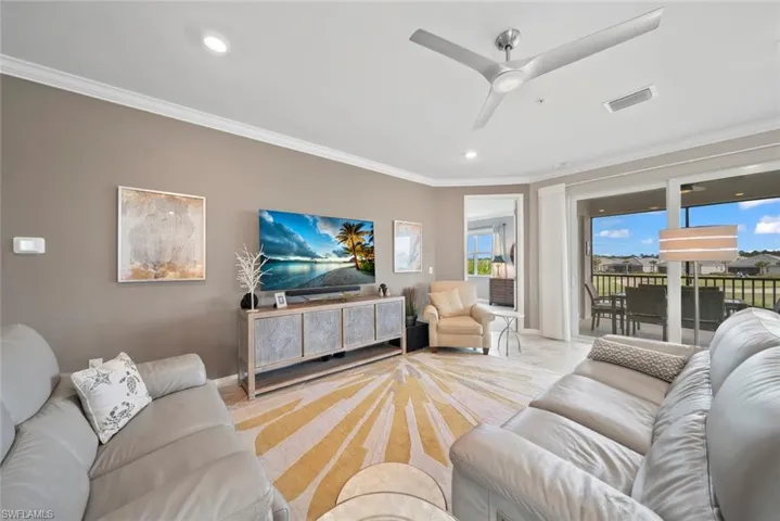 Living room with crown molding and ceiling fan