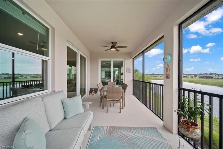 Sunroom featuring a water view and ceiling fan