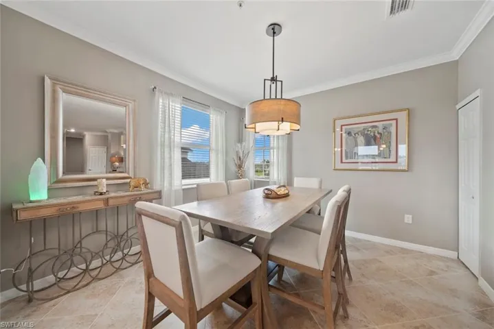 Tiled dining room with crown molding