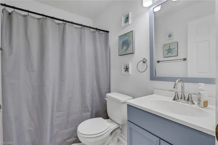 Bathroom featuring vanity and curtained shower