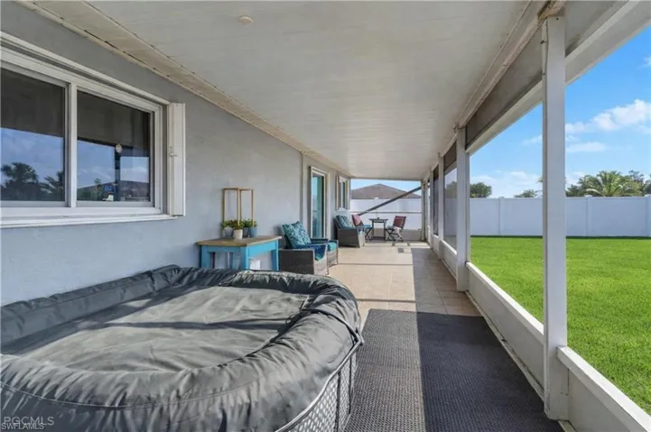 View of patio featuring a sunroom and outdoor lounge area