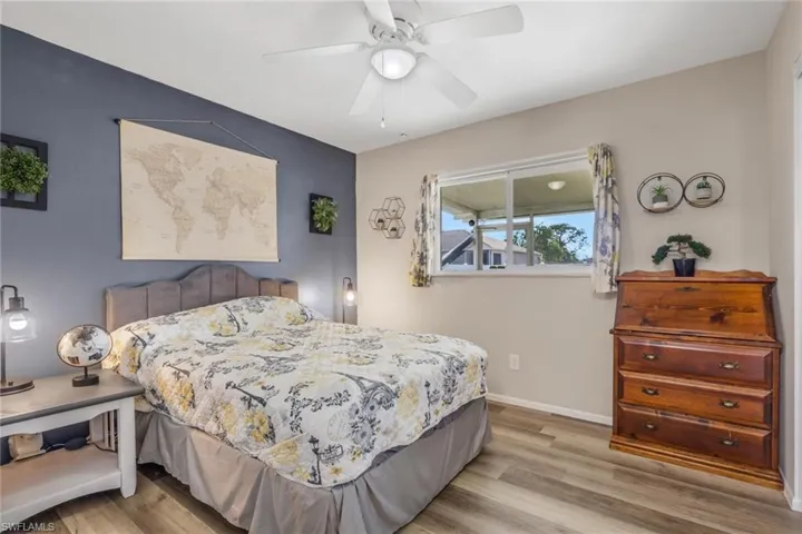 Bedroom with light wood finished floors and ceiling fan