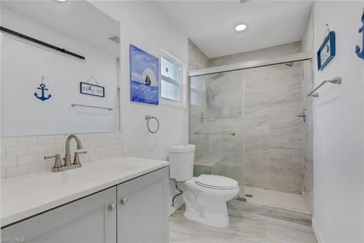 Bathroom with vanity and a stall shower
