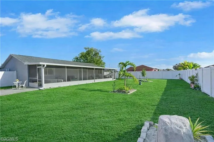 Fenced backyard with a sunroom