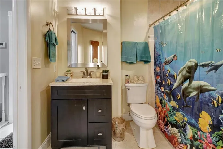 Bathroom with vanity, tile patterned flooring, and toilet