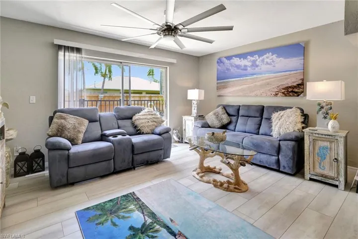 Living room with light hardwood / wood-style flooring and ceiling fan