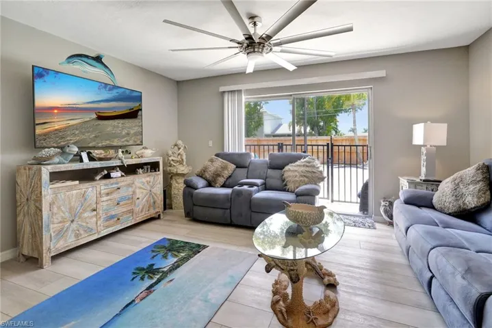 Living room featuring light wood-type flooring and ceiling fan