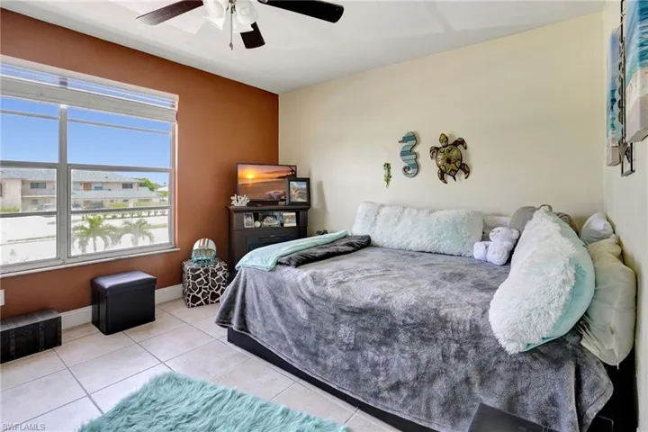 Tiled bedroom with ceiling fan