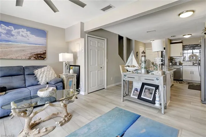 Living room with light hardwood / wood-style floors, sink, and ceiling fan
