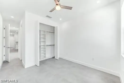 2nd Bedroom in Second Unit featuring custom closets with concrete flooring, ceiling fan, and recessed lighting