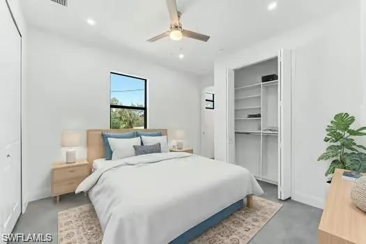 Primary Bedroom (Virtual Staged) in second unit (Staged)featuring concrete floors, recessed lighting, ceiling fan, and a closet