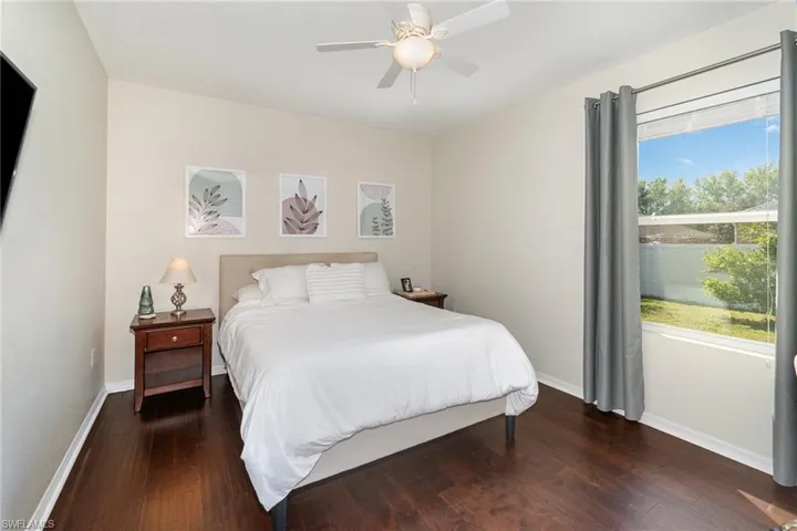 Bedroom featuring baseboards, ceiling fan, and wood finished floors
