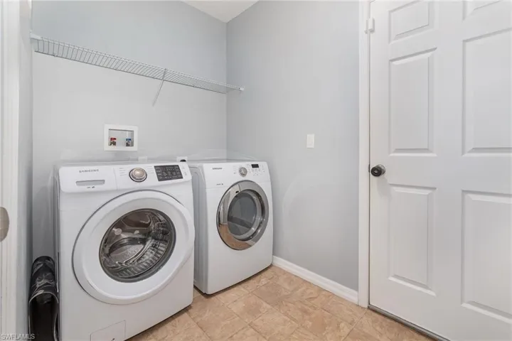 Laundry area featuring baseboards, laundry area, and separate washer and dryer