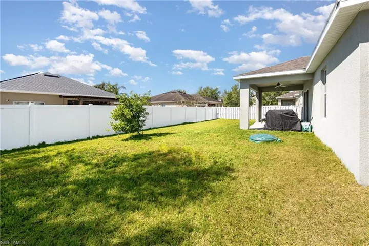 View of yard featuring a fenced backyard and a ceiling fan