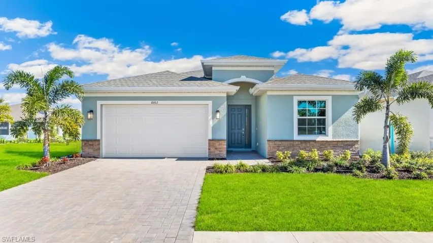 Model home. View of front of property featuring a garage, stone siding, driveway, and stucco siding
