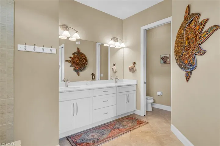 Bathroom featuring tile patterned floors, vanity, and toilet