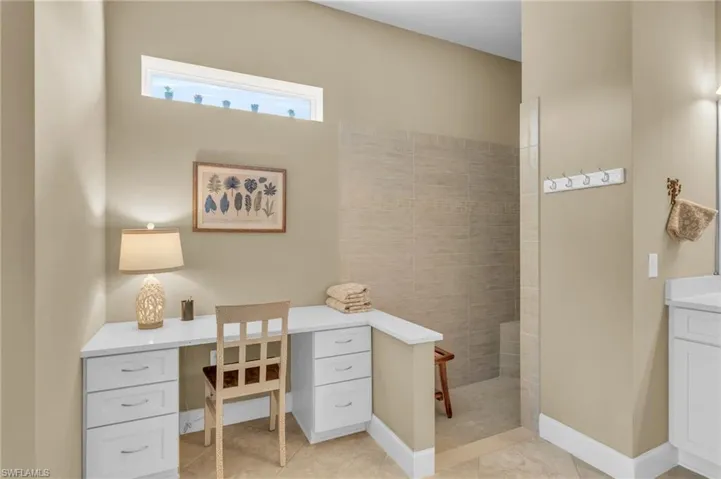 Tiled home office or make up area featuring built in desk