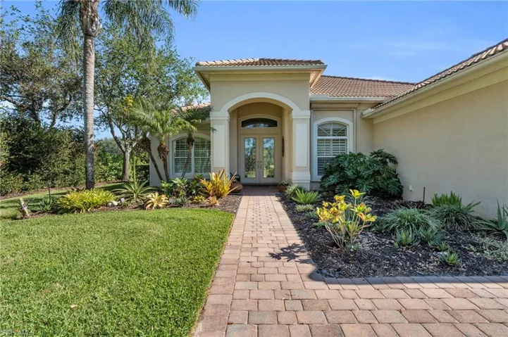 Doorway to property featuring front yard and french doors