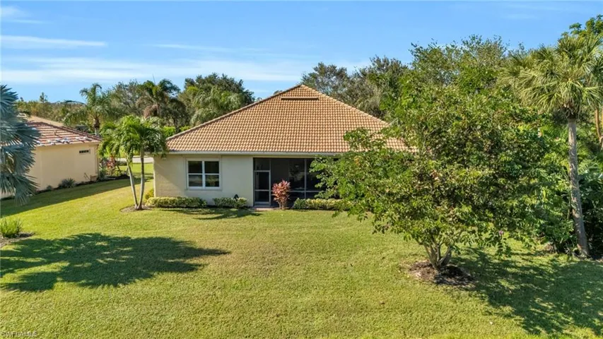 Rear view of property with a lawn