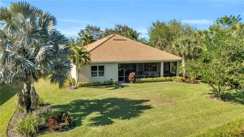 View of front facade featuring a sunroom and a front yard