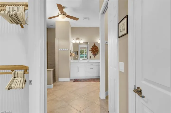 Bathroom with vanity, tile patterned floors, and ceiling fan