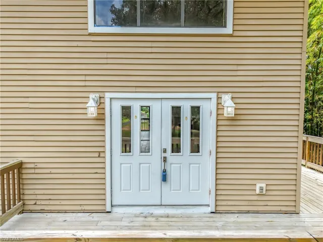 Doorway to property featuring a wooden deck