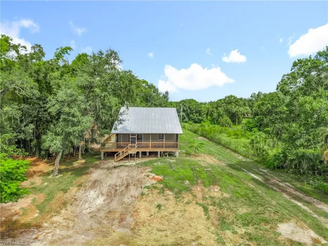 View from above of property featuring a heavily wooded area