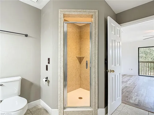 Full bath featuring light tile patterned floors and a stall shower