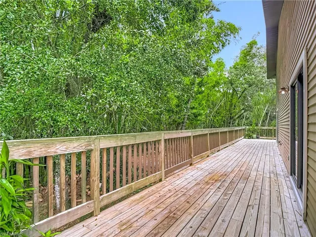 Wooden deck with view of wooded area
