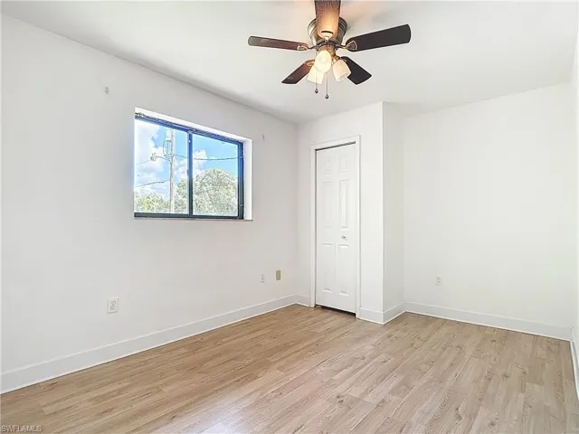 Unfurnished bedroom featuring light wood-type flooring, ceiling fan, and a closet