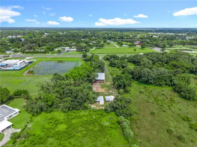 Aerial view of a tree filled landscape and a nearby body of water