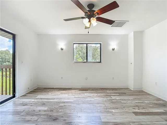 Spare room with light wood-type flooring and a ceiling fan