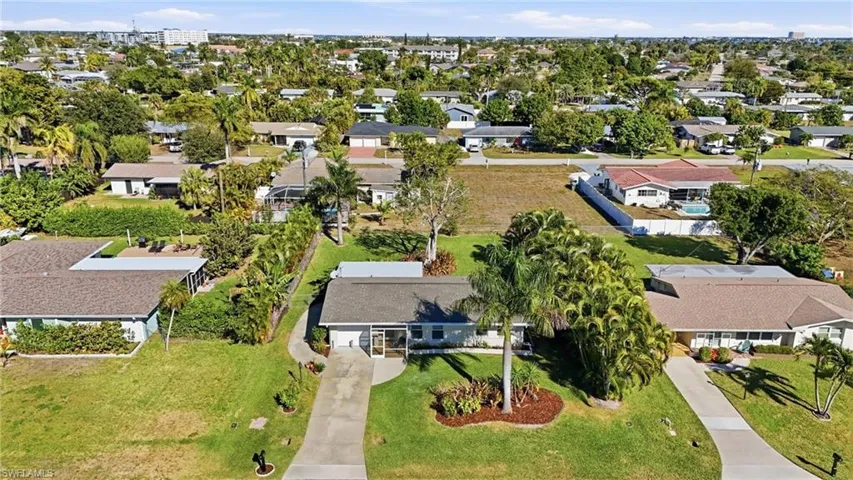 Aerial view of property's location with nearby suburban area
