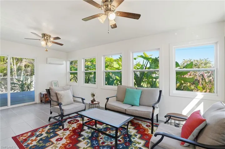 Sunroom with a wall mounted air conditioner