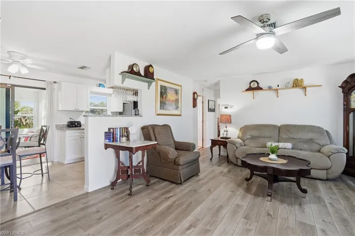 Living area with a ceiling fan and light wood finished floors
