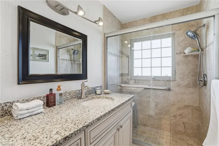 Bathroom with a stall shower and vanity