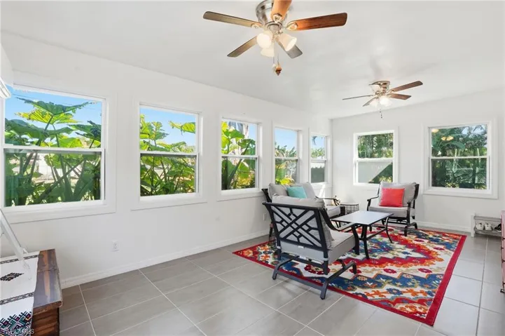 Sunroom featuring baseboards and tile patterned flooring