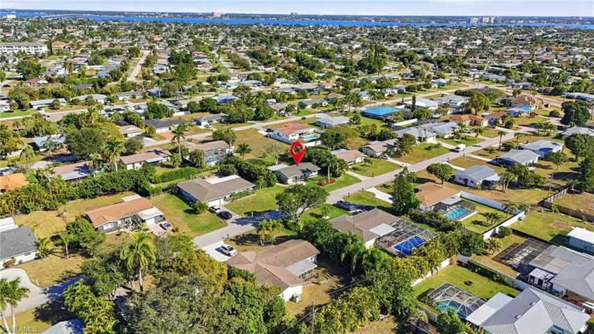Aerial view of property and surrounding area with nearby suburban area