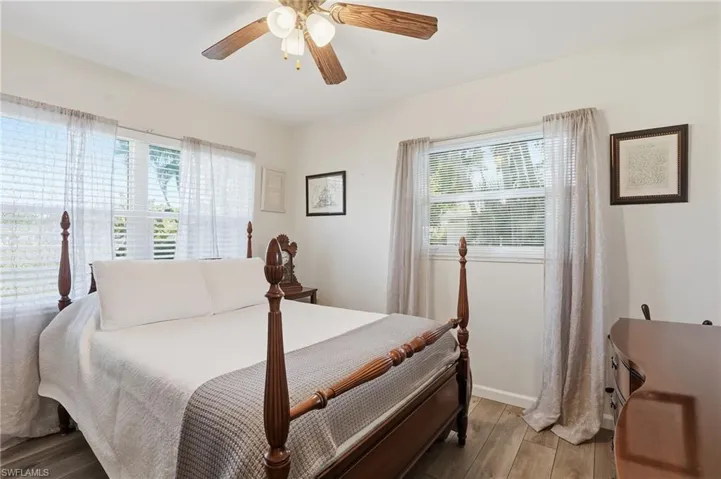 Bedroom with wood finished floors and ceiling fan
