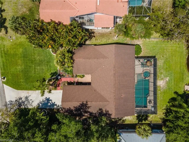 Aerial perspective showcasing a property with a brown shingle roof