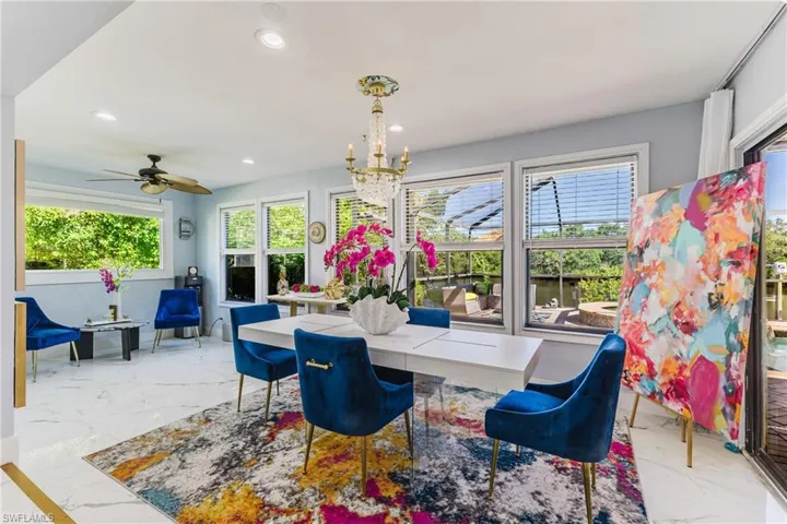 Dining area featuring recessed lighting, a chandelier, and multiple windows with horizontal blinds